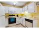 Functional kitchen with white cabinetry, modern appliances, and ample countertop space at 3164 S Wheeling Way # 302, Aurora, CO 80014