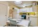 Bright kitchen featuring white appliances and cabinets, along with a dining area, perfect for casual meals at 3164 S Wheeling Way # 302, Aurora, CO 80014