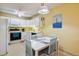 Cozy kitchen with white cabinets, complemented by a breakfast nook and decorative lighting fixture at 3164 S Wheeling Way # 302, Aurora, CO 80014