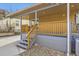 Inviting back porch features a wood railing and access to the yard, offering a cozy outdoor space at 3440 Chase St, Wheat Ridge, CO 80212