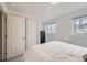 Bright bedroom featuring a queen-sized bed, a closet, and large windows allowing ample natural light at 3440 Chase St, Wheat Ridge, CO 80212
