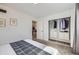 Bright bedroom featuring an organized closet system and neutral decor at 3440 Chase St, Wheat Ridge, CO 80212