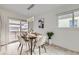 Inviting dining area with modern lighting, a stylish table, and sliding glass doors at 3440 Chase St, Wheat Ridge, CO 80212