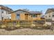 Charming home features a modern fence, a well-maintained lawn, and tasteful exterior color scheme at 3440 Chase St, Wheat Ridge, CO 80212