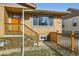 Stunning home entrance with wood stairs, stone veneer, and a modern wooden fence at 3440 Chase St, Wheat Ridge, CO 80212