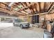Large garage interior featuring exposed wooden beams and a car, perfect for storage and hobbies at 3440 Chase St, Wheat Ridge, CO 80212