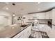 Bright kitchen featuring white cabinetry, stainless steel appliances, and a large center island with a sink at 3440 Chase St, Wheat Ridge, CO 80212