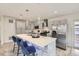 Modern kitchen features stainless steel appliances, a large island with seating, and stylish pendant lighting at 3440 Chase St, Wheat Ridge, CO 80212