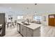 Bright, open-concept kitchen with island, stainless appliances, and elegant pendant lighting at 3440 Chase St, Wheat Ridge, CO 80212