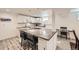 Bright kitchen with stainless steel appliances, island, and bar seating at 3440 Chase St, Wheat Ridge, CO 80212