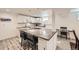 Basement kitchen with large island and bar stool seating offering a functional workspace at 3440 Chase St, Wheat Ridge, CO 80212