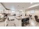 Basement kitchen with white cabinets, stainless appliances and oversized island with barstool seating at 3440 Chase St, Wheat Ridge, CO 80212