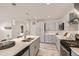 Stylish gray kitchen featuring quartz countertops, stainless appliances, and modern backsplash at 3440 Chase St, Wheat Ridge, CO 80212