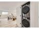 Convenient laundry area featuring stacked washer and dryer units, maximizing space at 3440 Chase St, Wheat Ridge, CO 80212
