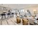 Bright and airy living room seamlessly blends into the open-concept kitchen and dining area at 3440 Chase St, Wheat Ridge, CO 80212