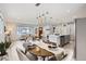 Open-concept living space with seamless flow between the dining area, living room, and modern kitchen at 3440 Chase St, Wheat Ridge, CO 80212