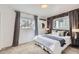 Cozy bedroom featuring stylish wallpaper, large windows, and plush carpeting at 3440 Chase St, Wheat Ridge, CO 80212