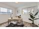 Bright home office with two large windows, modern desk and stylish plant accents at 3440 Chase St, Wheat Ridge, CO 80212