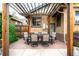 A backyard patio features a dining table with a pergola and string lights at 1918 S Lincoln St, Denver, CO 80210