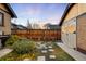 Cozy backyard with a wooden fence, raised garden beds, and stone pathway at 1918 S Lincoln St, Denver, CO 80210