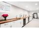 Basement bar features a long butcher block countertop and dual wine refrigerators at 1918 S Lincoln St, Denver, CO 80210