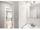 This bright bathroom with its tile floors, offers a stylish vanity at 1918 S Lincoln St, Denver, CO 80210