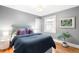 Inviting bedroom with a comfortable bed, soft lighting, and hardwood floors at 1918 S Lincoln St, Denver, CO 80210