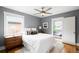 Comfortable bedroom with ceiling fan, neutral walls, and a large window at 1918 S Lincoln St, Denver, CO 80210