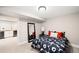 Finished basement bedroom with flower bedding, mirror, and bar area in the hall at 1918 S Lincoln St, Denver, CO 80210