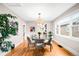 Bright dining room with hardwood floors and modern light fixture and access to the kitchen at 1918 S Lincoln St, Denver, CO 80210