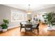 Open dining area featuring hardwood floors, modern lighting, with open access to the living room at 1918 S Lincoln St, Denver, CO 80210