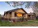 Charming brick home with a well-manicured lawn and inviting front porch with mature trees overhead at 1918 S Lincoln St, Denver, CO 80210