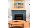 Close-up of the modern fireplace with attractive mantle, tile work and hardwood floors at 1918 S Lincoln St, Denver, CO 80210