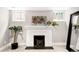 Finished basement with white brick fireplace, art, and mirror at 1918 S Lincoln St, Denver, CO 80210