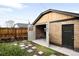 Detached garage with stylish doors, brick facade, and a stone pathway at 1918 S Lincoln St, Denver, CO 80210