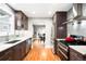 This kitchen features stainless steel appliances, white marble counters, and dark cabinets at 1918 S Lincoln St, Denver, CO 80210