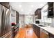 Modern kitchen featuring stainless steel appliances, subway tile backsplash, and breakfast nook at 1918 S Lincoln St, Denver, CO 80210