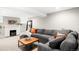 Finished basement living room with fireplace, grey couch, and coffee table at 1918 S Lincoln St, Denver, CO 80210