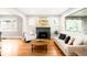 Bright living room features a modern fireplace and an abundance of natural light from large windows at 1918 S Lincoln St, Denver, CO 80210