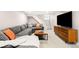 Finished basement living room with grey couch, staircase, and tv at 1918 S Lincoln St, Denver, CO 80210