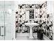 Powder room with floral wallpaper, pedestal sink, grey floors, and glass enclosed shower at 1918 S Lincoln St, Denver, CO 80210