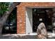 The exterior of Sushi Den restaurant shows brick and stone details at 1918 S Lincoln St, Denver, CO 80210