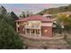 Brick house with tile roof, deck, and mountain views at 6321 Spotted Fawn Run, Littleton, CO 80125