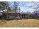 Inviting backyard with a wooden deck, well-maintained lawn, and mature trees, perfect for outdoor living at 7209 S Sherman St, Centennial, CO 80122