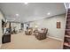 Finished basement offering versatile space, featuring a TV area, workout zone, and neutral carpet at 7209 S Sherman St, Centennial, CO 80122