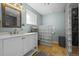 Well-lit bathroom with a modern vanity, glass block partition, and tiled shower at 7209 S Sherman St, Centennial, CO 80122