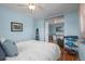 Stylish bedroom with hardwood floors, a decorative shelf, and an open view into the adjacent room at 7209 S Sherman St, Centennial, CO 80122