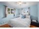 Cozy bedroom featuring hardwood floors, a ceiling fan and natural light from the two windows at 7209 S Sherman St, Centennial, CO 80122