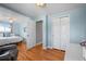 Bright bedroom with hardwood floors and a closet, leading into a bonus room at 7209 S Sherman St, Centennial, CO 80122