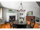 Cozy dining room features a fireplace, hardwood floors, and elegant lighting, perfect for intimate gatherings at 7209 S Sherman St, Centennial, CO 80122